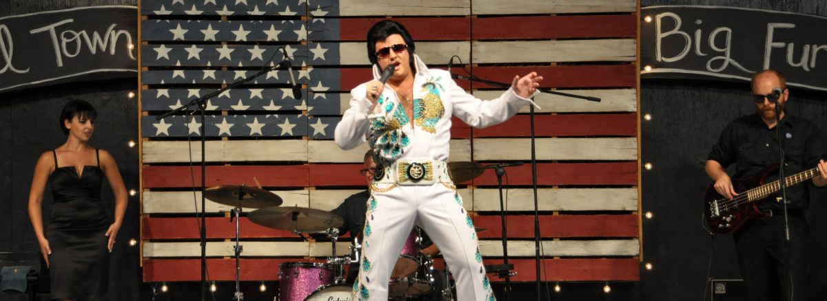 Elvis impersonator on stage with band