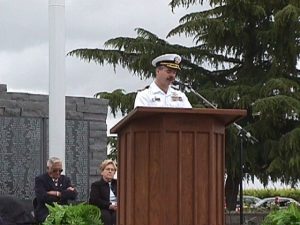 man giving a speech on a podium.