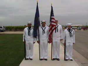 Four men holding memorial flags