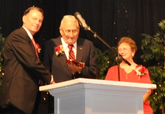 three people standing at podium