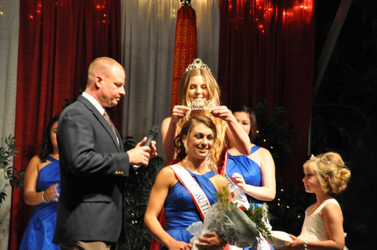 Girl placing crown on other girl's head