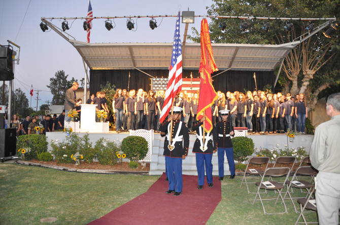 men in uniform walking with american flag