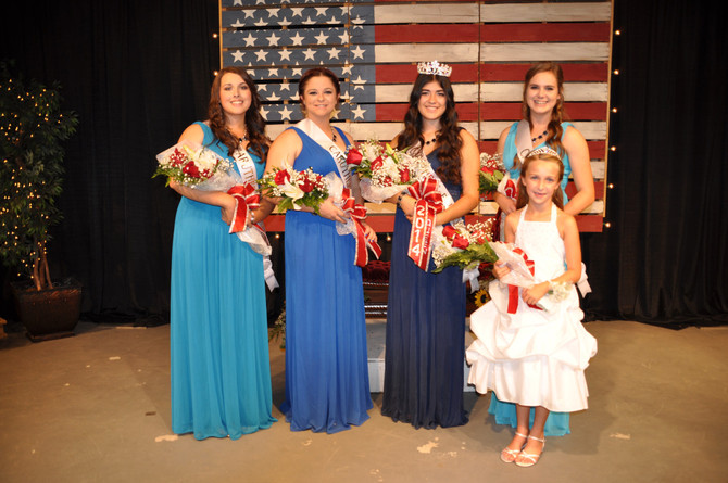 5 girls with sashes and bouquet of flowers standing in front of american flag