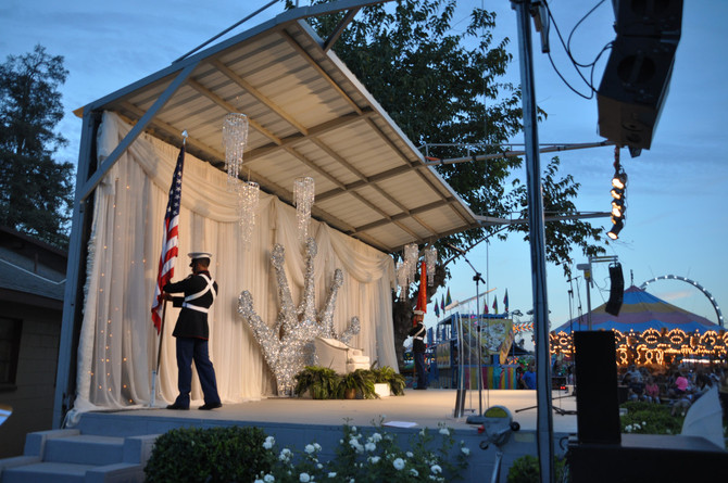 men in uniform placing flags on stage