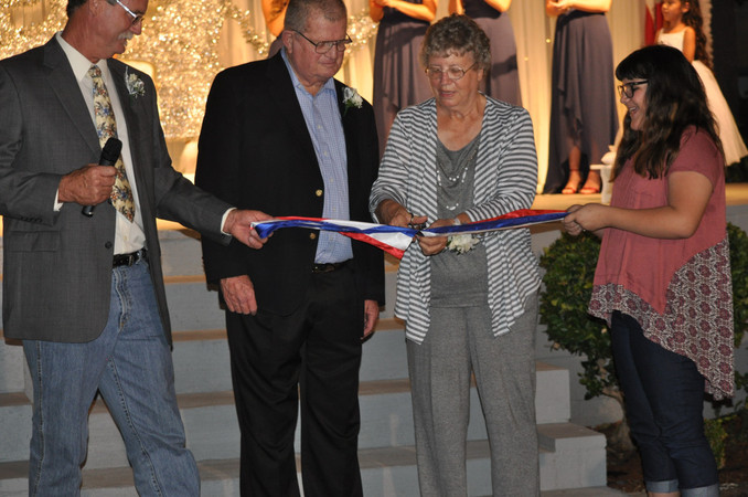 woman cutting ribbon with scissors