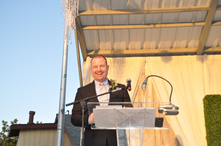 man smiling at podium