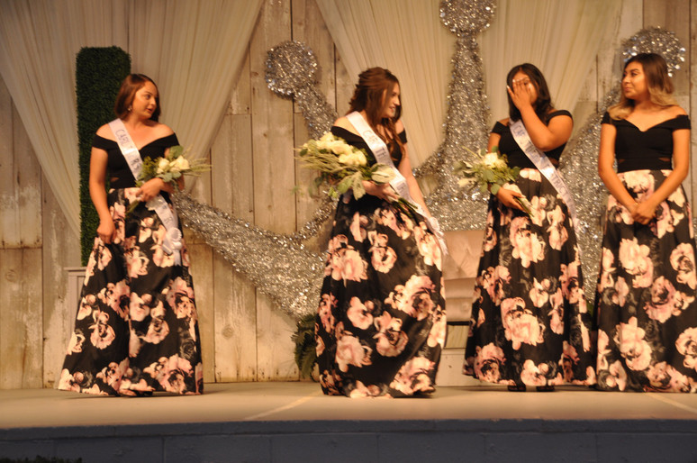 girls on stage with sashes and bouquet of flowers