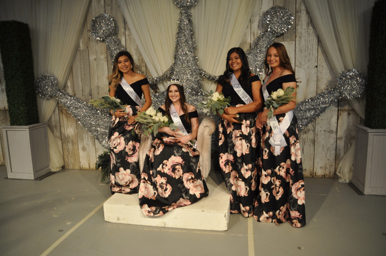 girls on stage with sashes and bouquets of flowers