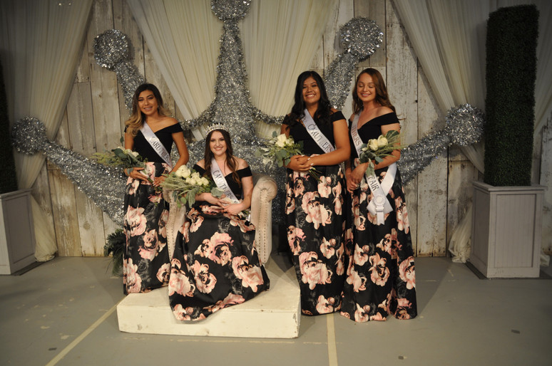 girls on stage with sashes and bouquets of flowers