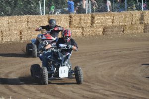 two racers driving atvs on the track