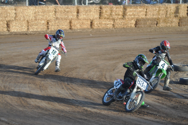 three racers driving motorcycles on the race track