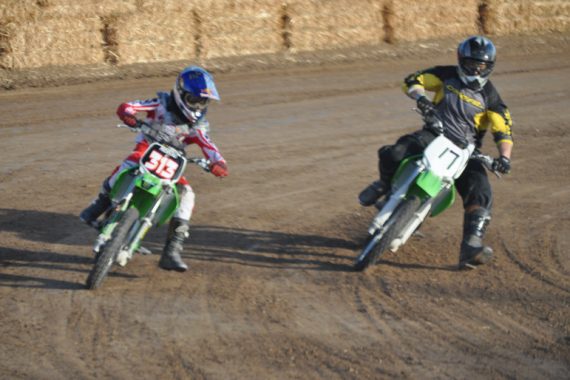 two racers driving motorcycles on the race track