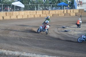 two racers driving motorcycles on the race track