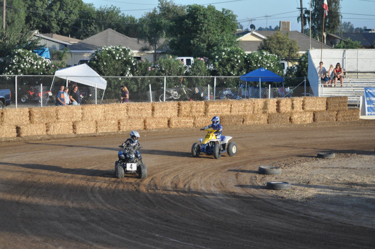 two young racers driving atvs on the race track